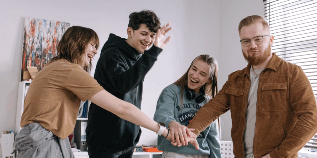 Team laughing and having fun in an office, showing personality and a behind-the-scenes look at the workplace